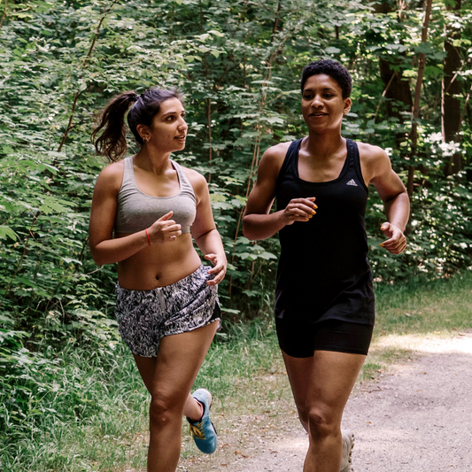 2 people jogging on a trail